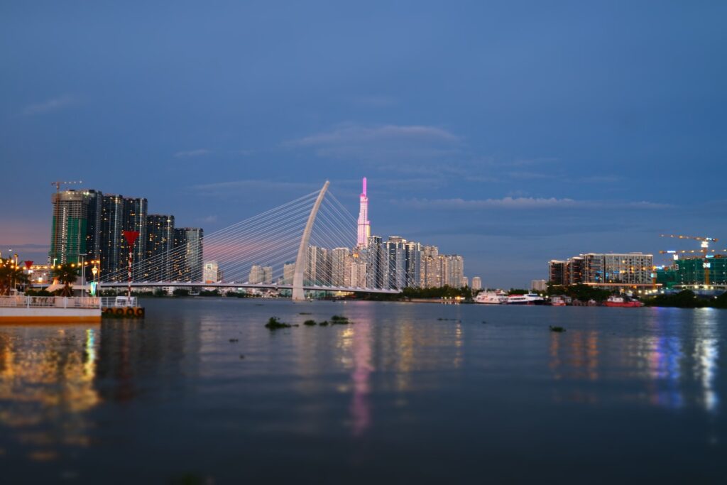 a bridge over water with buildings in the background